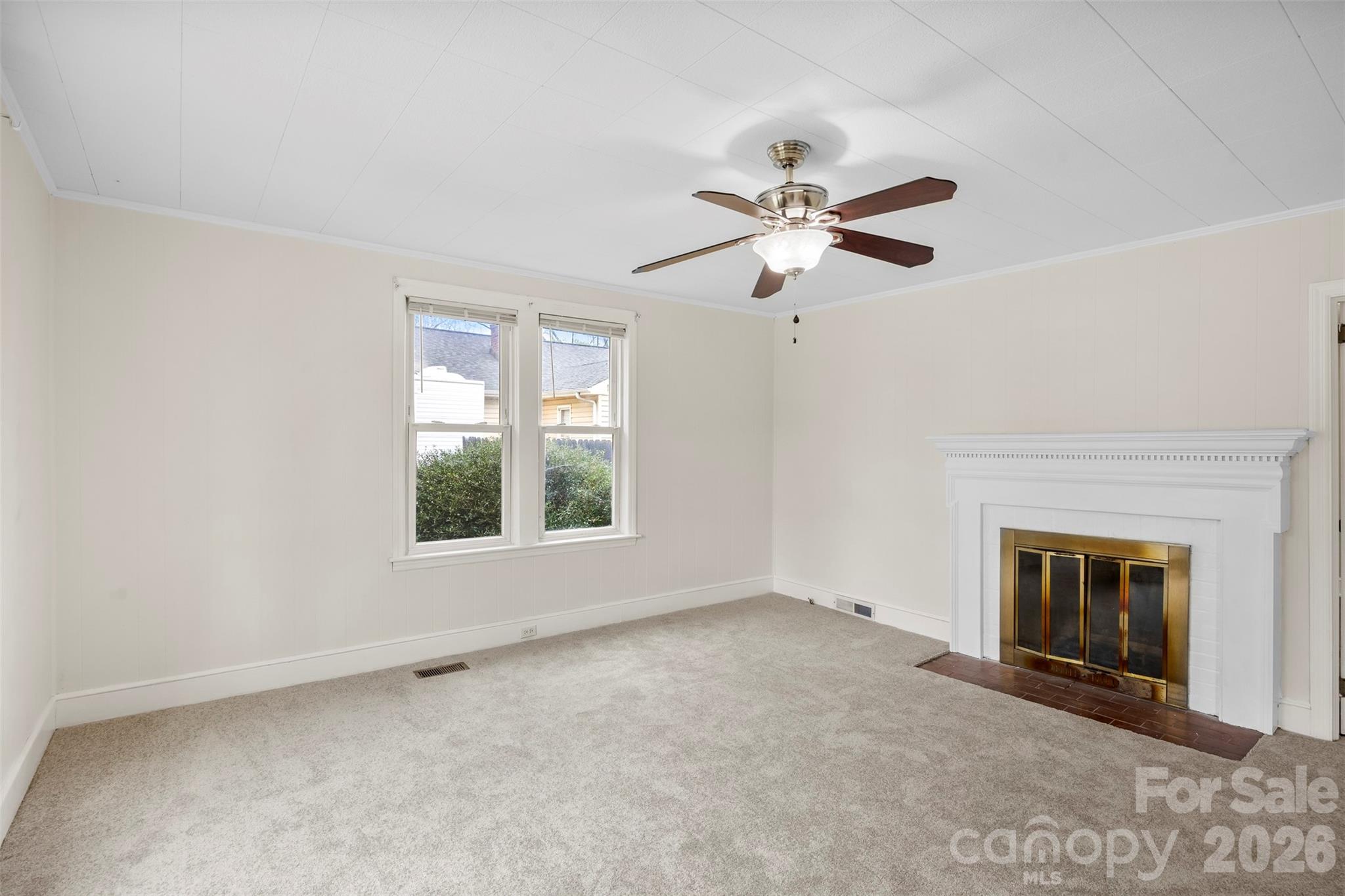 302 South Maple Street Dallas, NC 28034 - Photo 5 of 25 an empty room with windows and fireplace