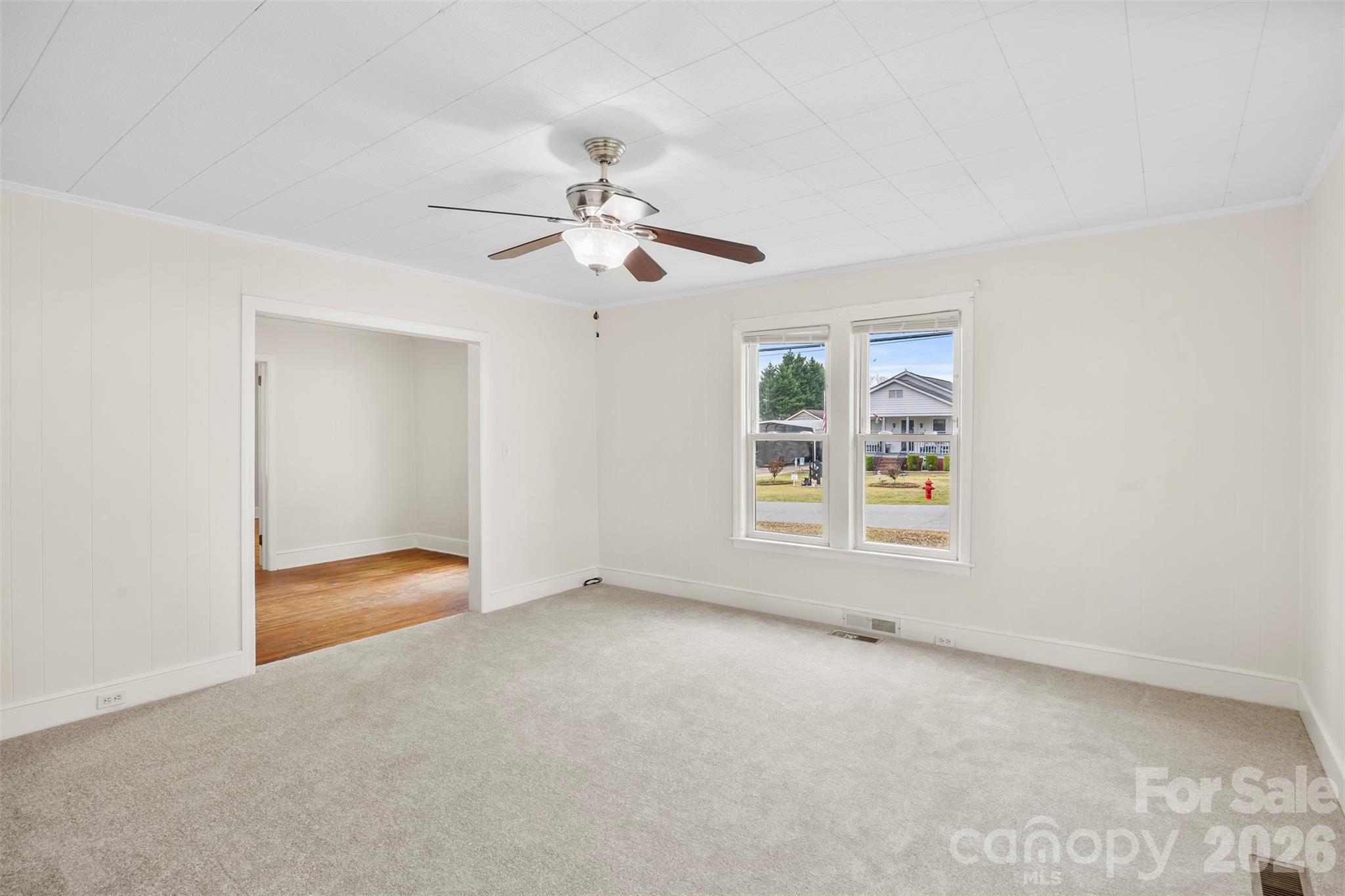 302 South Maple Street Dallas, NC 28034 - Photo 6 of 25 an empty room with a ceiling fan and window