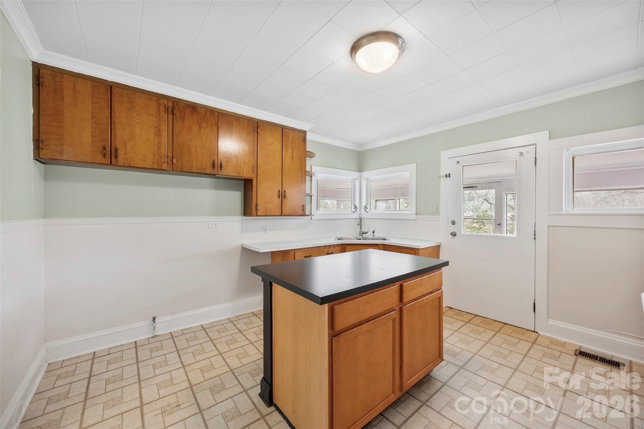 302 South Maple Street Dallas, NC 28034 - Photo 9 of 25 a kitchen with stainless steel appliances granite countertop a sink stove and cabinets
