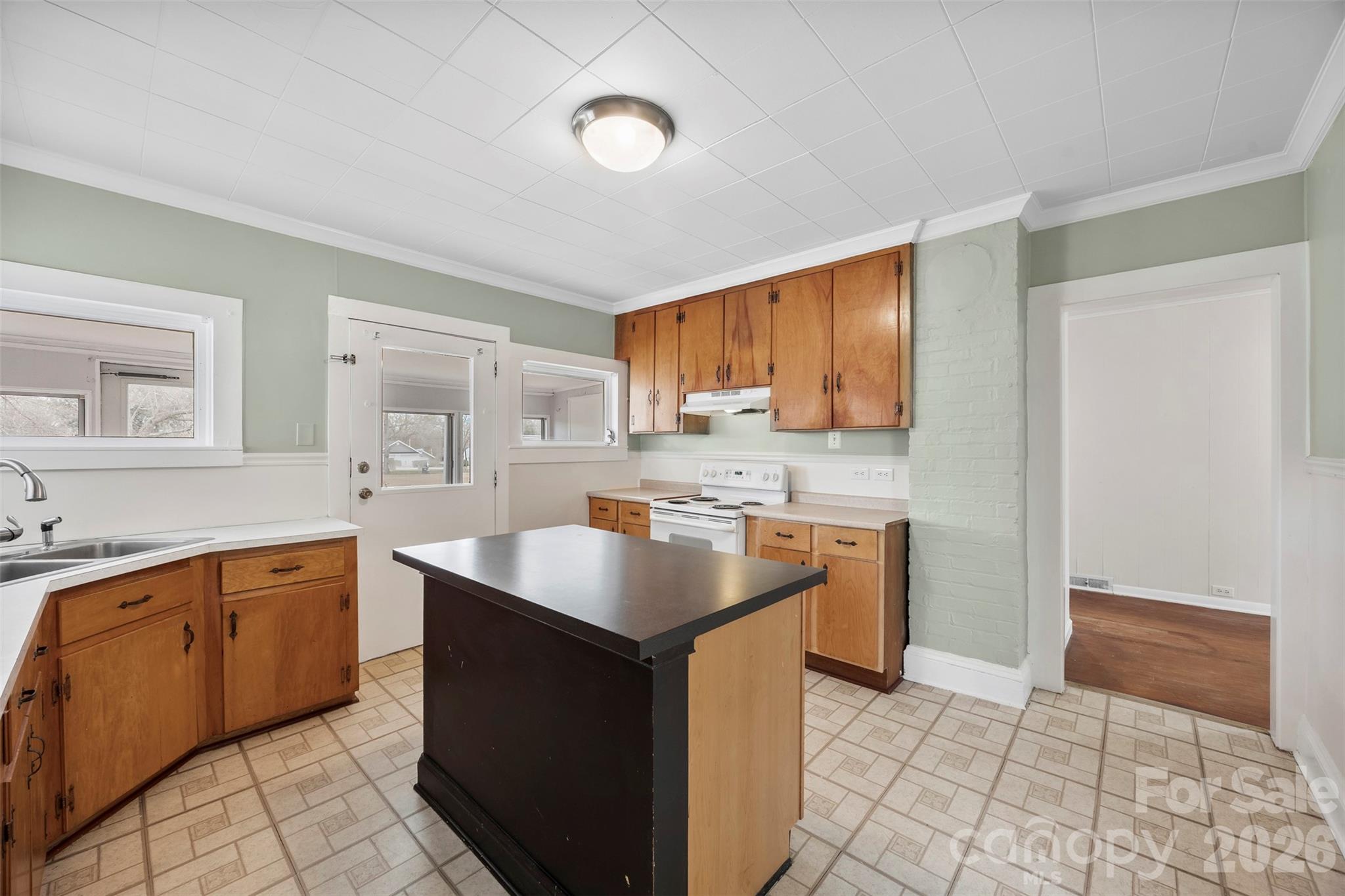 302 South Maple Street Dallas, NC 28034 - Photo 10 of 25 a kitchen with stainless steel appliances granite countertop a sink counter space cabinets and a window