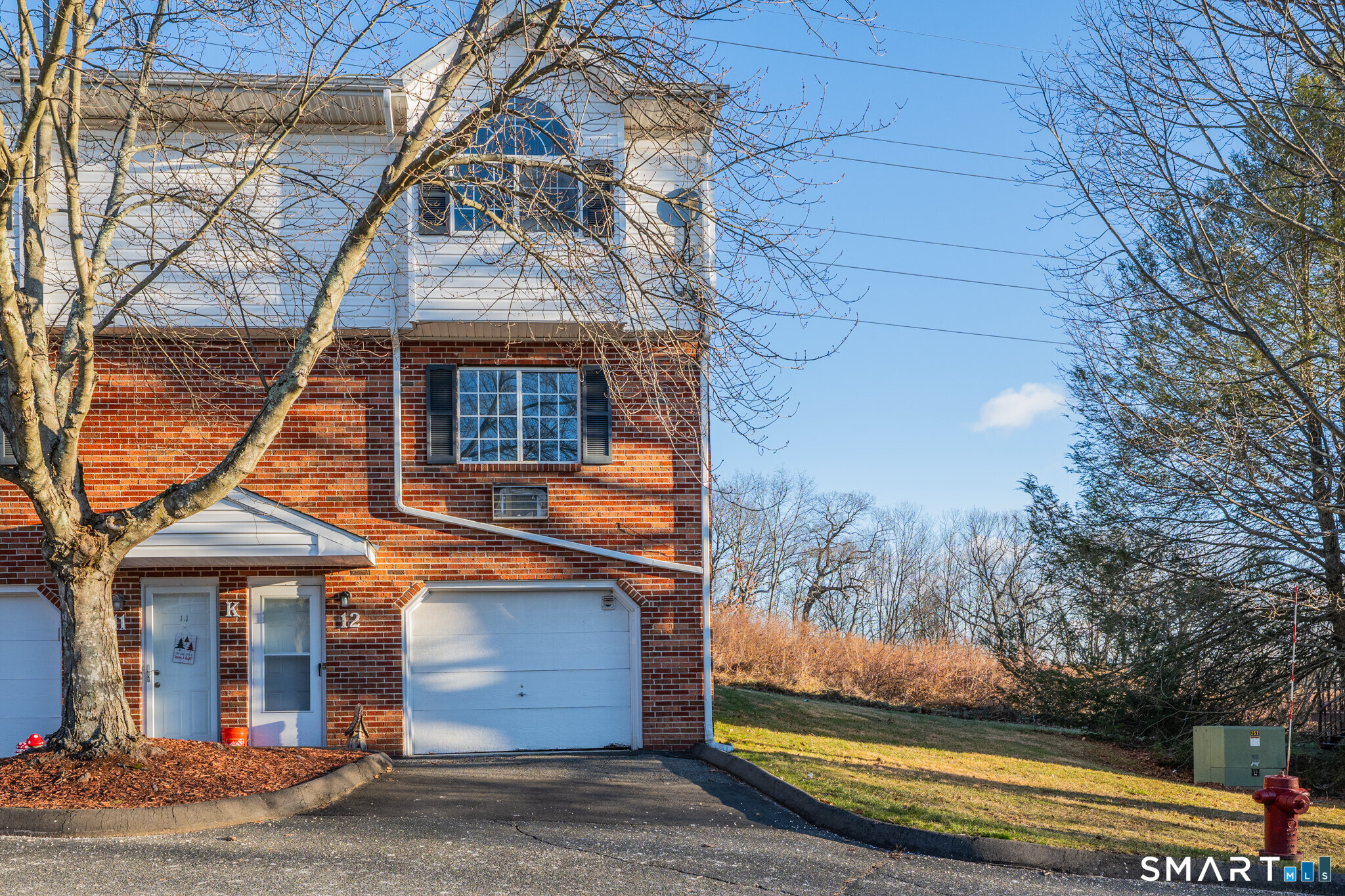 24 Blue Ridge Drive, Unit K12 Waterbury, CT 06704 - Photo 1 of 15 a front view of a house with a yard