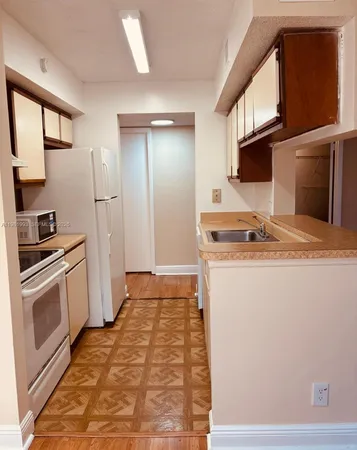 a kitchen with a sink stove and refrigerator