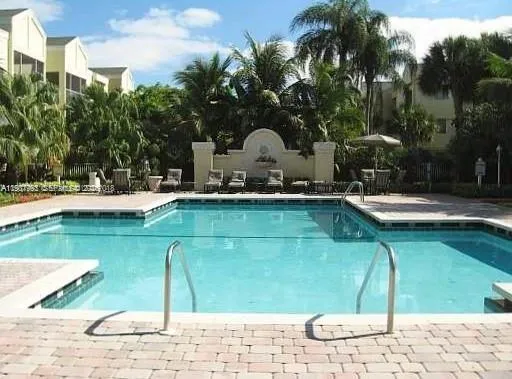 a swimming pool with outdoor seating and yard