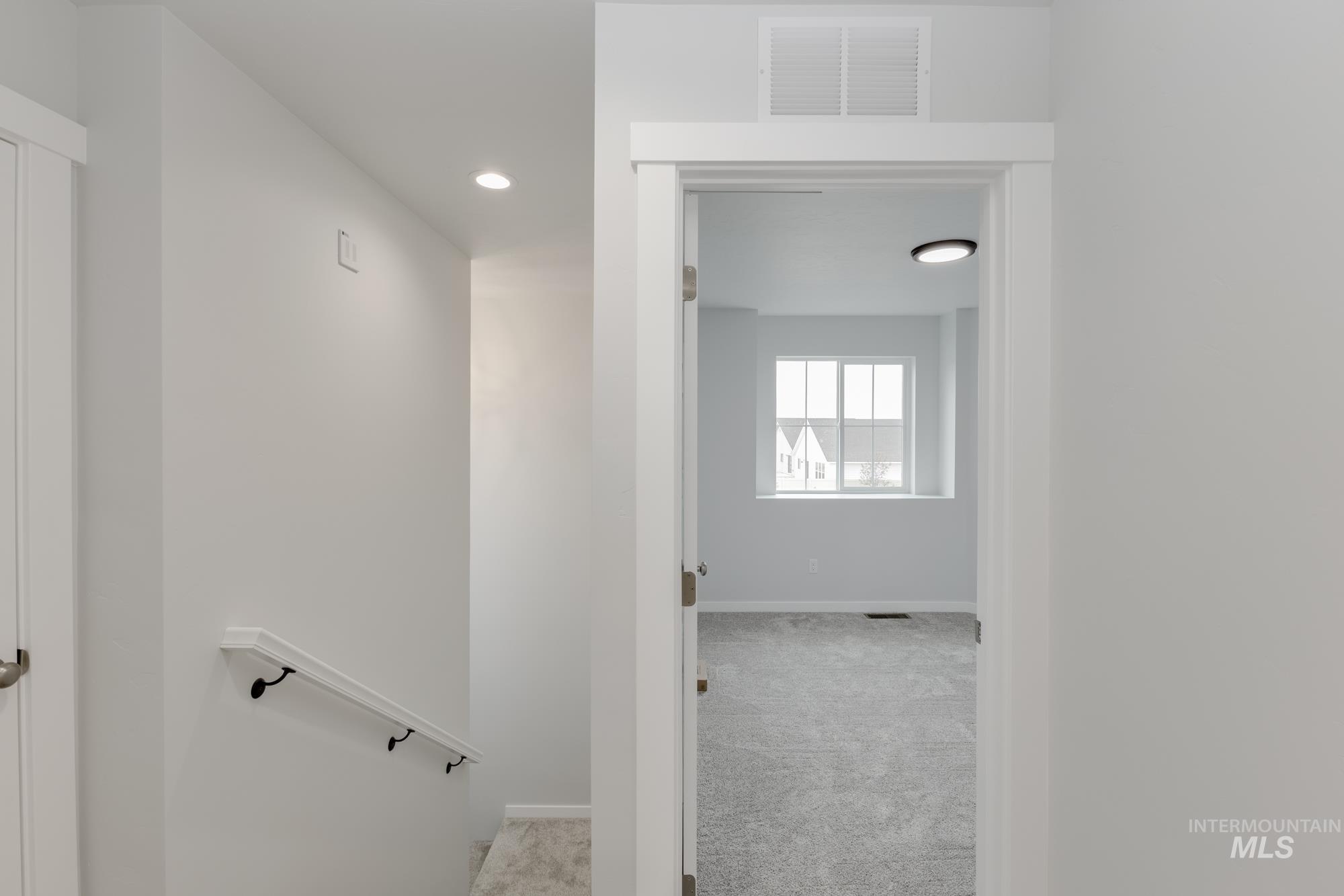 10873 Rutland Street Caldwell, ID 83605 - Photo 13 of 19 Corridor with light carpet and recessed lighting