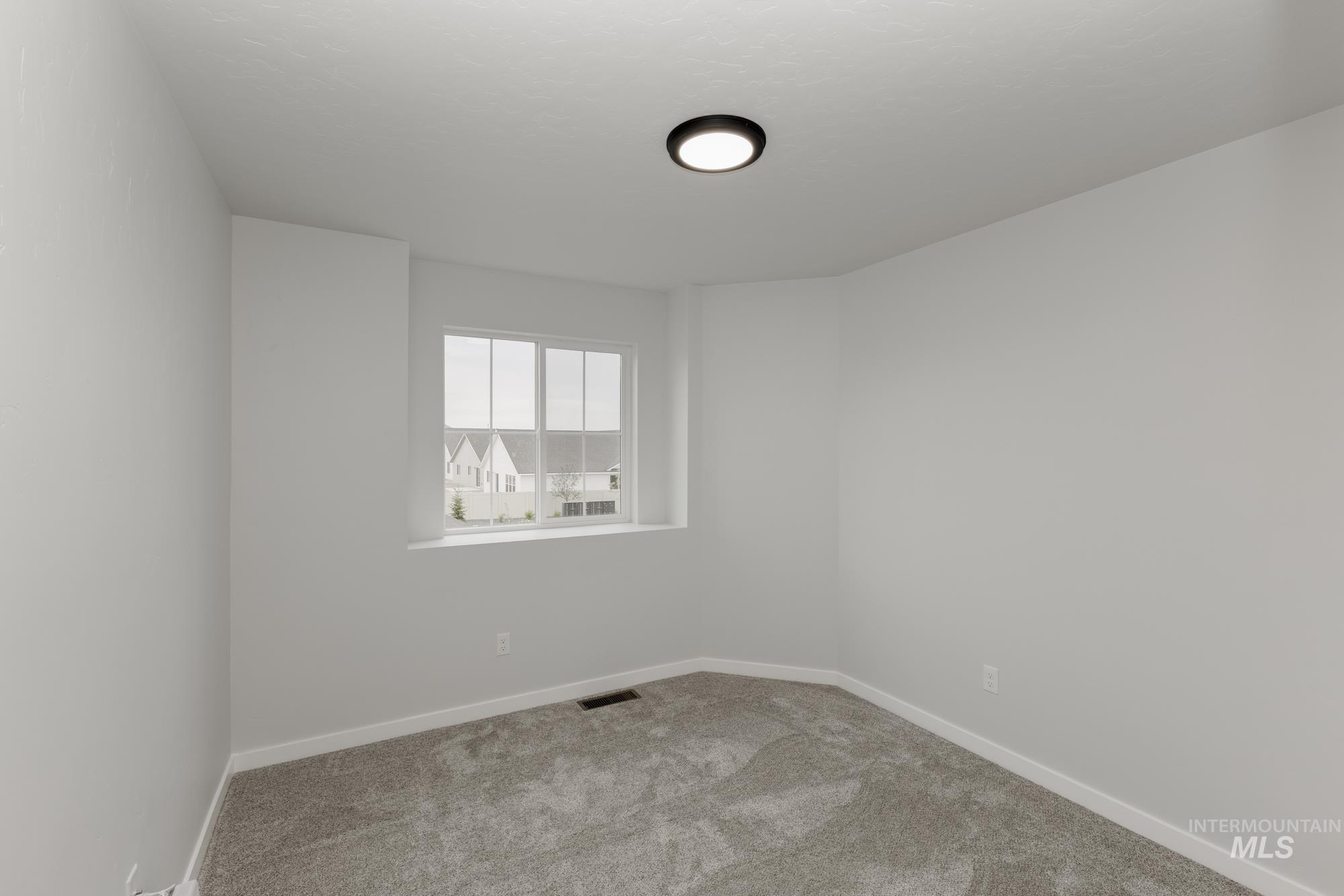 10873 Rutland Street Caldwell, ID 83605 - Photo 14 of 19 Unfurnished room featuring carpet floors and baseboards