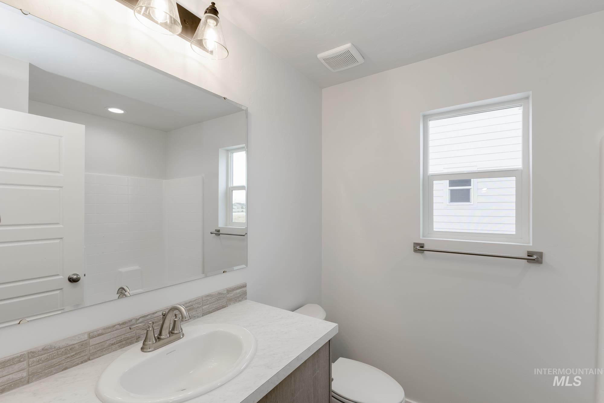 10873 Rutland Street Caldwell, ID 83605 - Photo 15 of 19 Bathroom featuring vanity and toilet