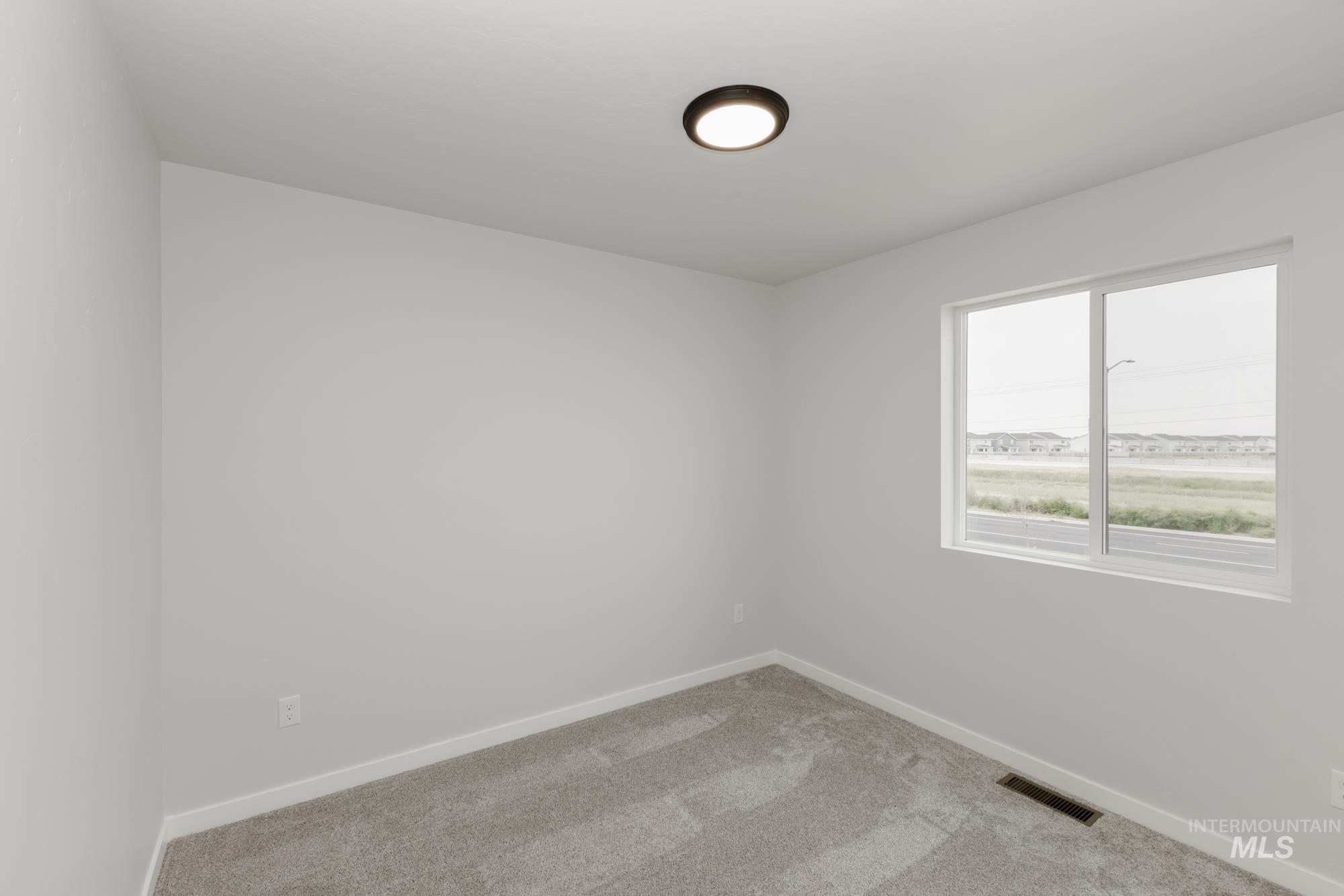 10873 Rutland Street Caldwell, ID 83605 - Photo 16 of 19 Carpeted empty room with baseboards