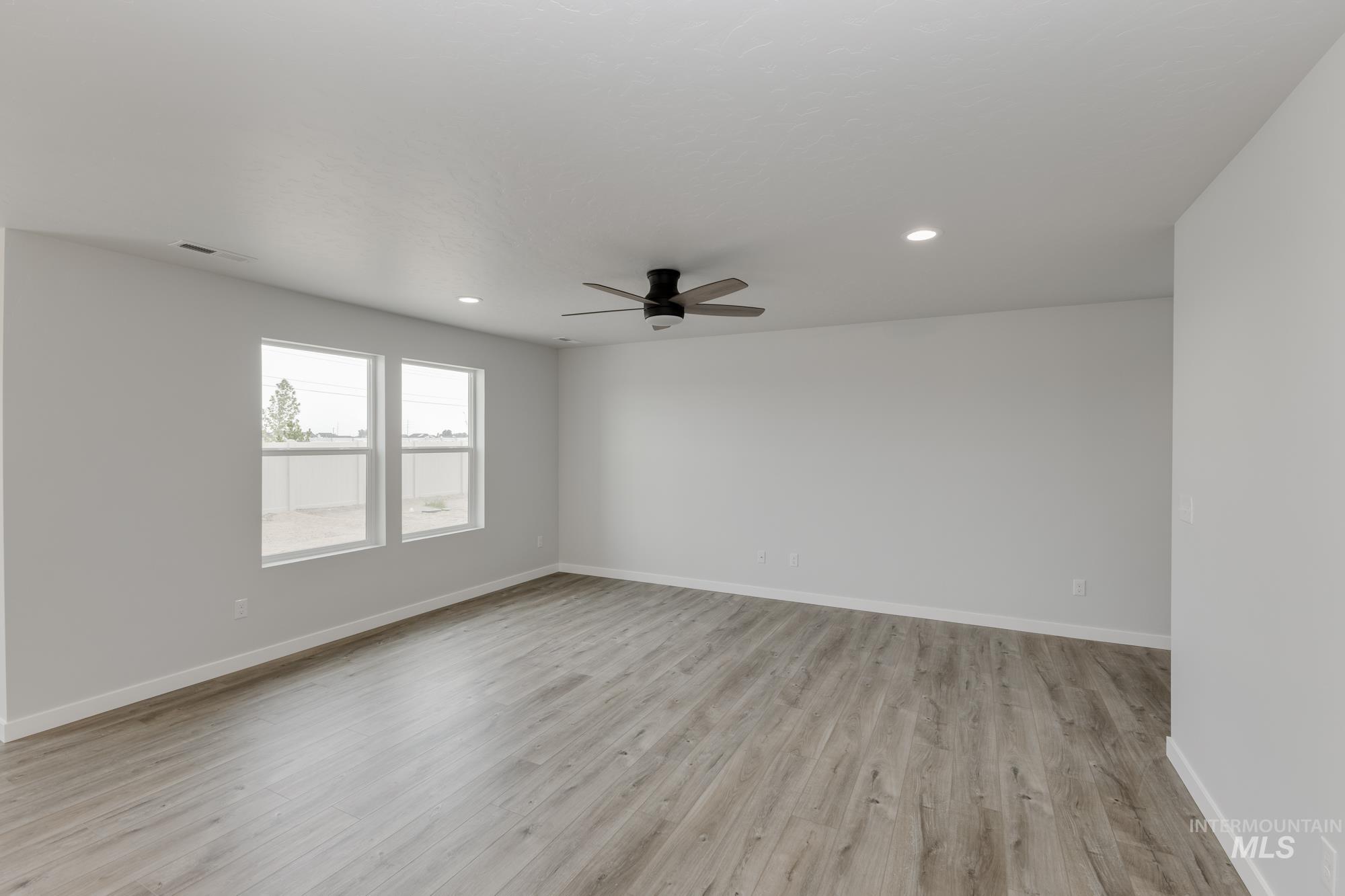10873 Rutland Street Caldwell, ID 83605 - Photo 8 of 19 Unfurnished room featuring light wood-style flooring, a ceiling fan, and recessed lighting