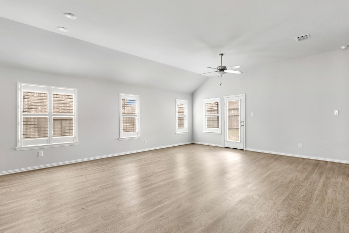 20811 Magical Merlin Way Tomball, TX 77375 - Photo 13 of 31 an empty room with wooden floor chandelier and windows