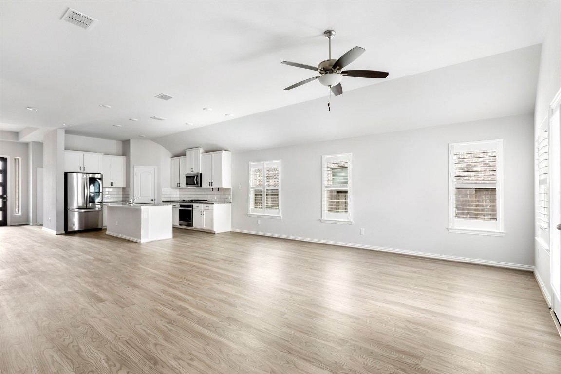 20811 Magical Merlin Way Tomball, TX 77375 - Photo 15 of 31 a view of a kitchen with wooden floor and a window
