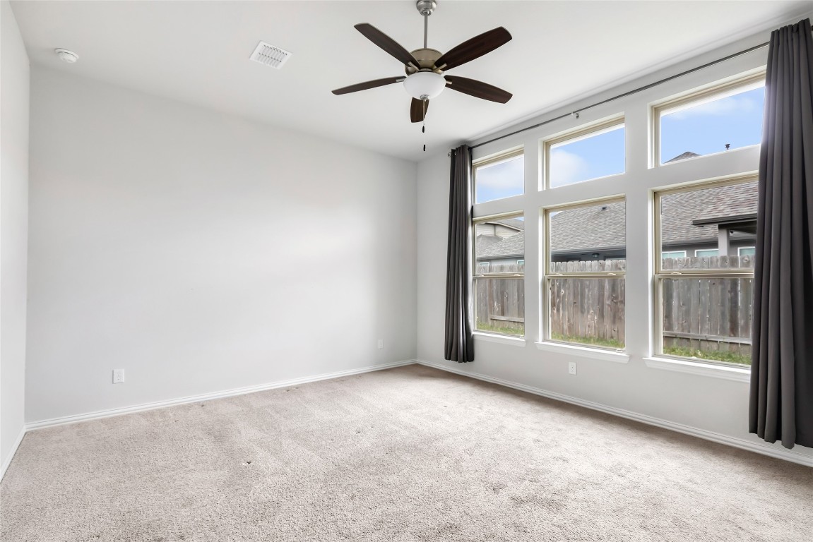 20811 Magical Merlin Way Tomball, TX 77375 - Photo 19 of 31 an empty room with windows and ceiling fan