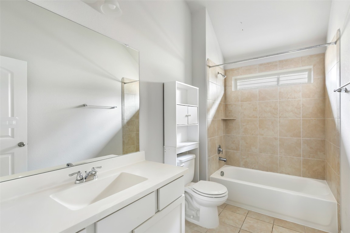 20811 Magical Merlin Way Tomball, TX 77375 - Photo 27 of 31 a bathroom with a sink a toilet and a large mirror