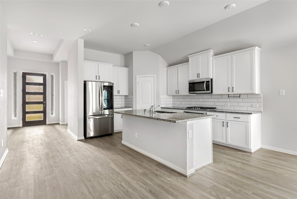 20811 Magical Merlin Way Tomball, TX 77375 - Photo 8 of 31 a kitchen with stainless steel appliances a refrigerator sink and microwave