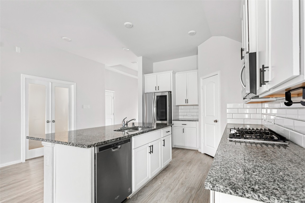 20811 Magical Merlin Way Tomball, TX 77375 - Photo 9 of 31 a kitchen with a sink stove and refrigerator