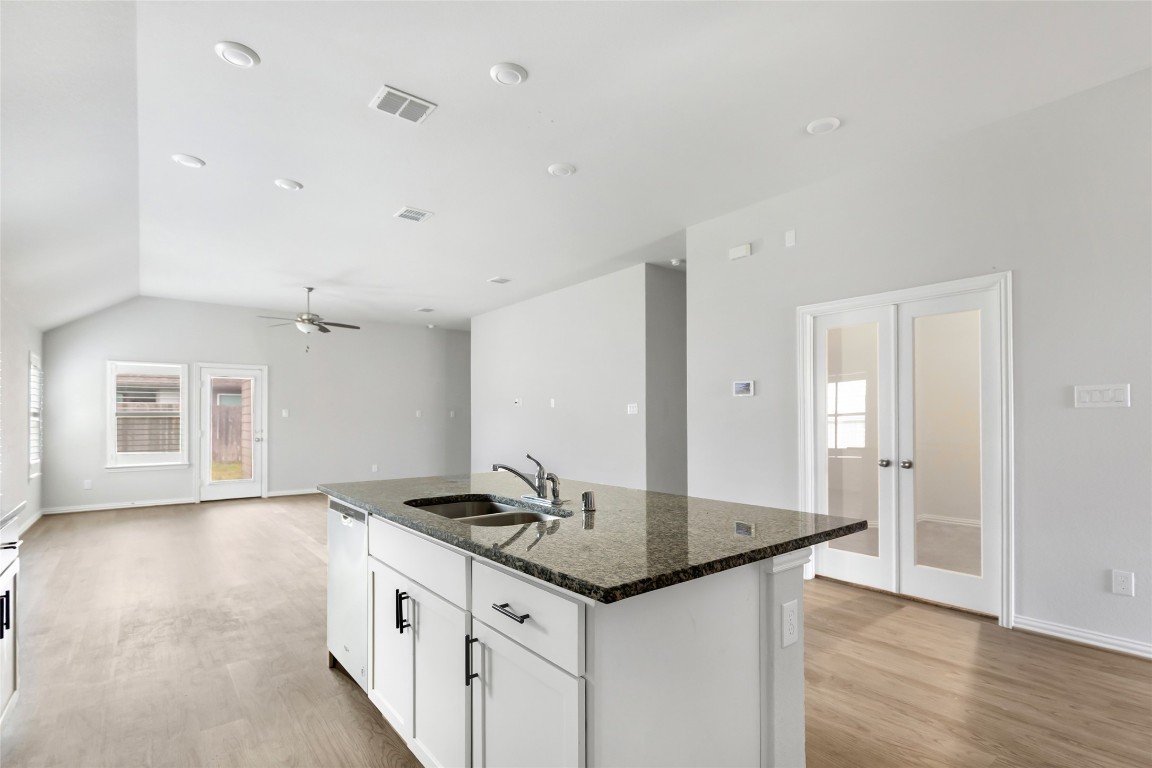 20811 Magical Merlin Way Tomball, TX 77375 - Photo 10 of 31 a kitchen with granite countertop a sink cabinets and wooden floor