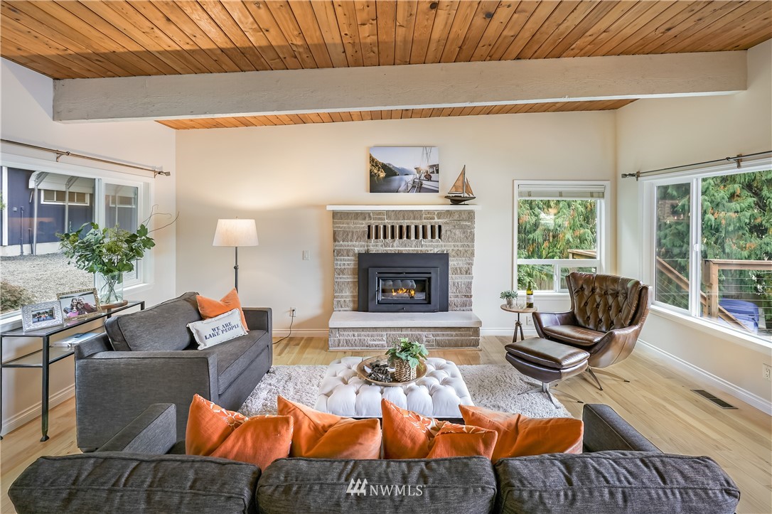 1817 Southwest Lake Roesiger Road Snohomish, WA 98290 - Photo 11 of 37 a living room with furniture fireplace and a large window