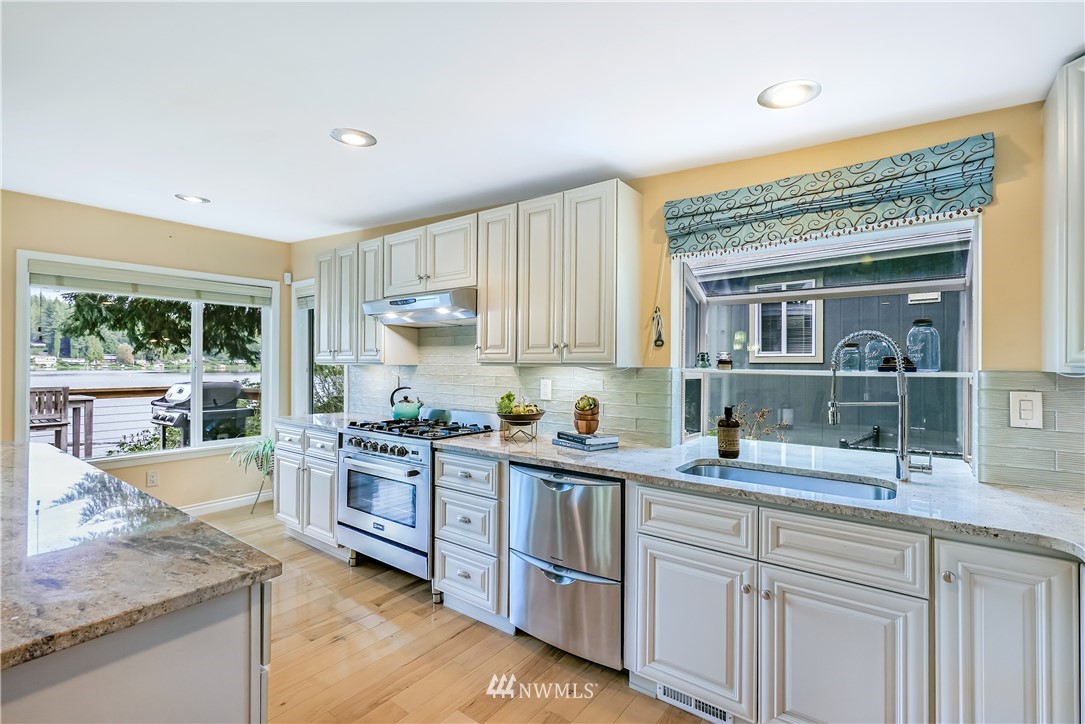 1817 Southwest Lake Roesiger Road Snohomish, WA 98290 - Photo 12 of 37 a kitchen with stainless steel appliances granite countertop a sink and cabinets