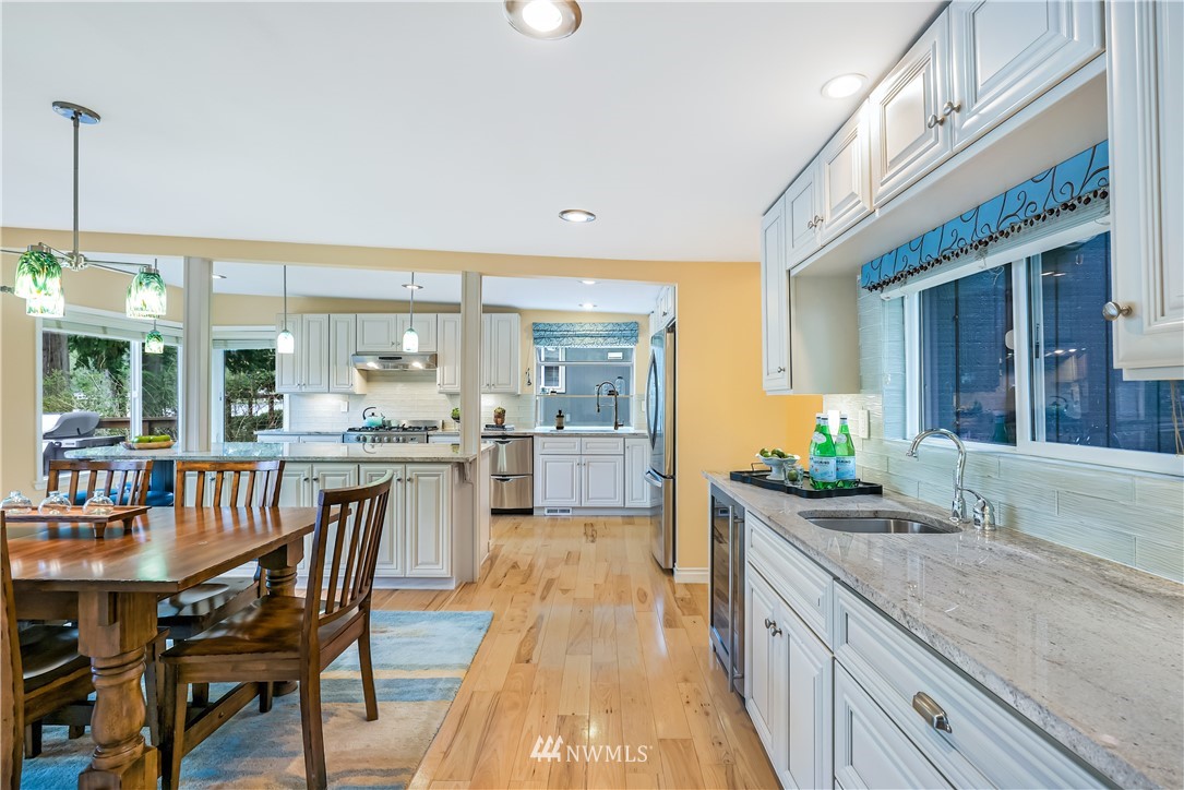 1817 Southwest Lake Roesiger Road Snohomish, WA 98290 - Photo 16 of 37 a view of a kitchen with kitchen island granite countertop wooden floor and a sink