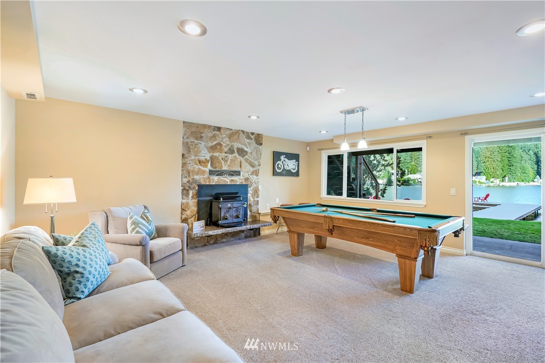 1817 Southwest Lake Roesiger Road Snohomish, WA 98290 - Photo 22 of 37 a living room with furniture and a fireplace