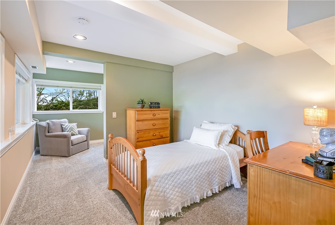 1817 Southwest Lake Roesiger Road Snohomish, WA 98290 - Photo 24 of 37 a bedroom with furniture and a large window