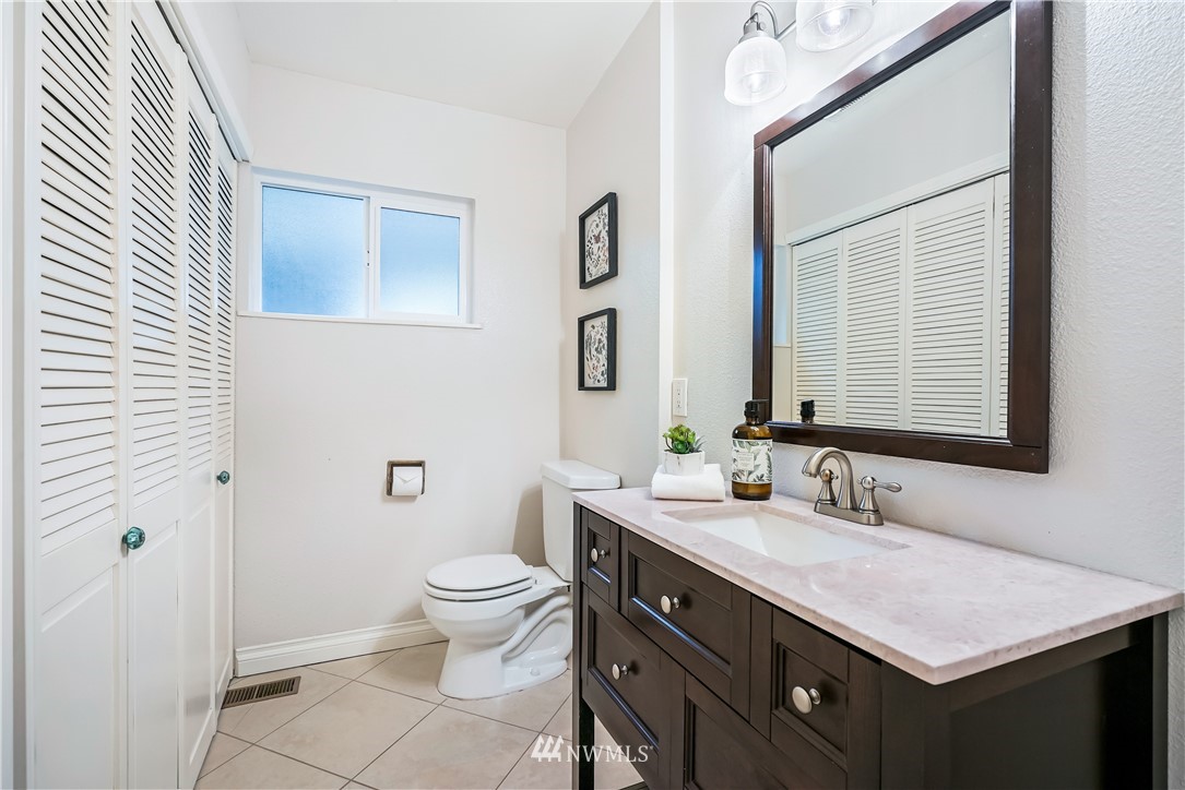 1817 Southwest Lake Roesiger Road Snohomish, WA 98290 - Photo 26 of 37 a bathroom with a sink a toilet and a mirror