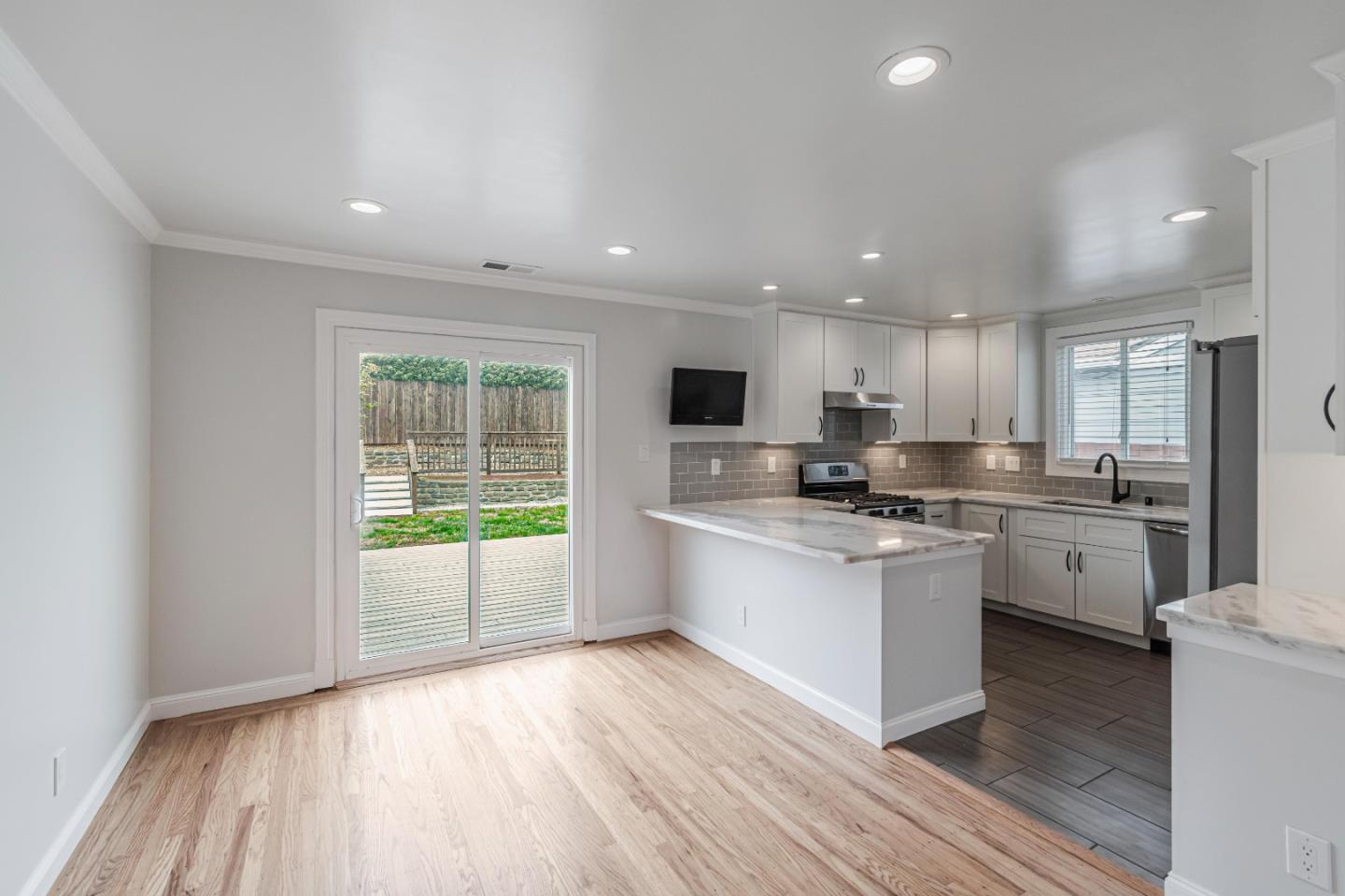 843 Beechwood Drive Daly City, CA 94015 - Photo 6 of 25 a kitchen with granite countertop a stove top oven sink and cabinets