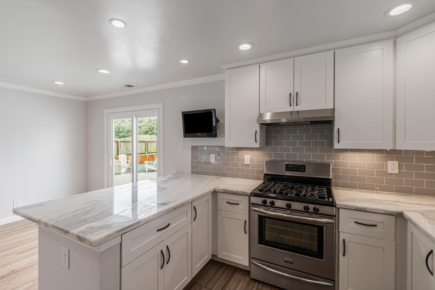 843 Beechwood Drive Daly City, CA 94015 - Photo 10 of 25 a kitchen with granite countertop a sink stove and cabinets