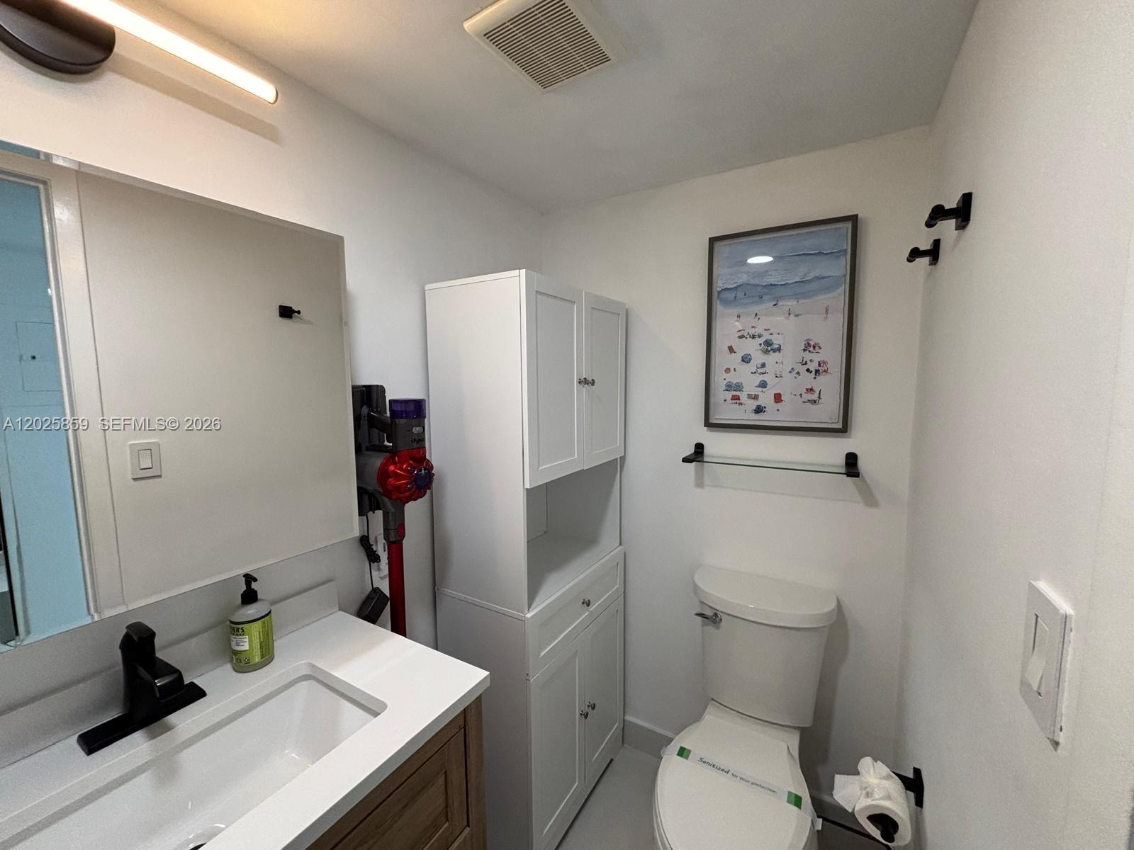 540 Brickell Key Drive, Unit 1024 Miami, FL 33131 - Photo 24 of 28 a bathroom with a sink vanity mirror and toilet