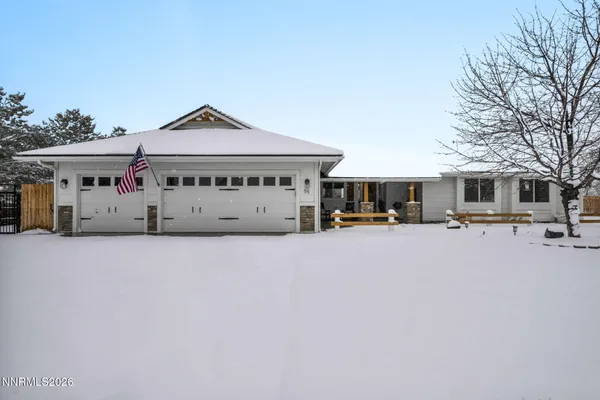 a view of swimming pool with outdoor seating and house in the background