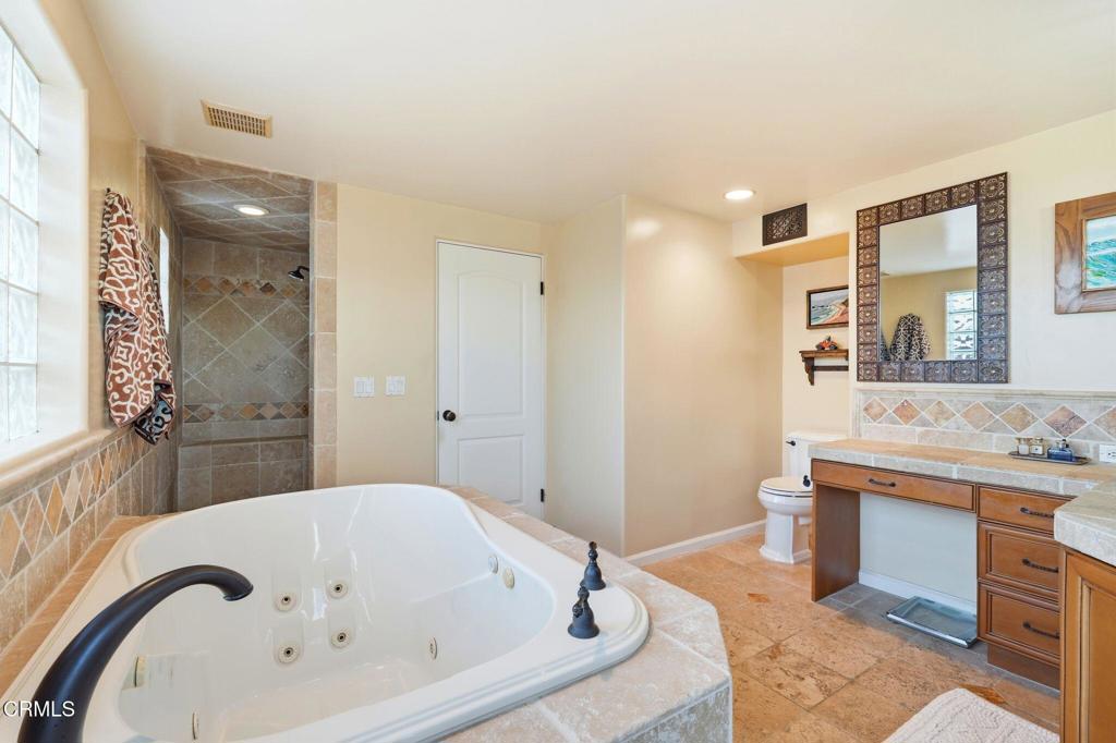137 Fillmore Avenue Oxnard, CA 93035 - Photo 43 of 73 a bathroom with a tub sink and mirror
