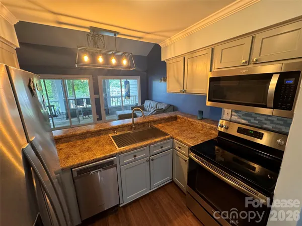 a kitchen with stainless steel appliances a stove and a microwave
