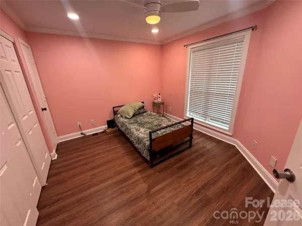 a living room with hard wood floors and a window