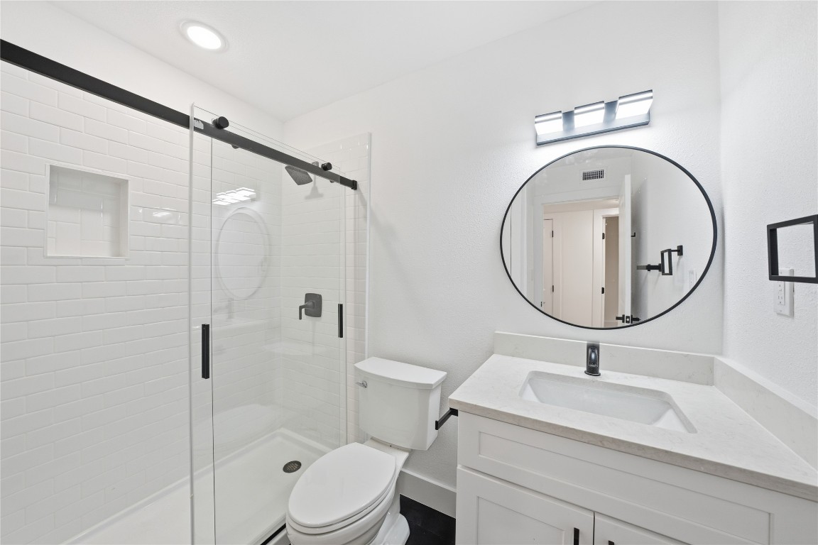 500 East Riverside Drive, Unit 133 Austin, TX 78704 - Photo 14 of 38 a bathroom with a sink a toilet and a mirror