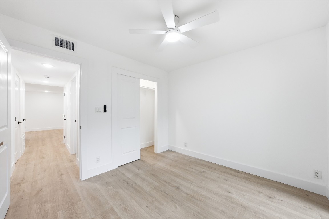 500 East Riverside Drive, Unit 133 Austin, TX 78704 - Photo 21 of 38 an empty room with wooden floor and a ceiling fan