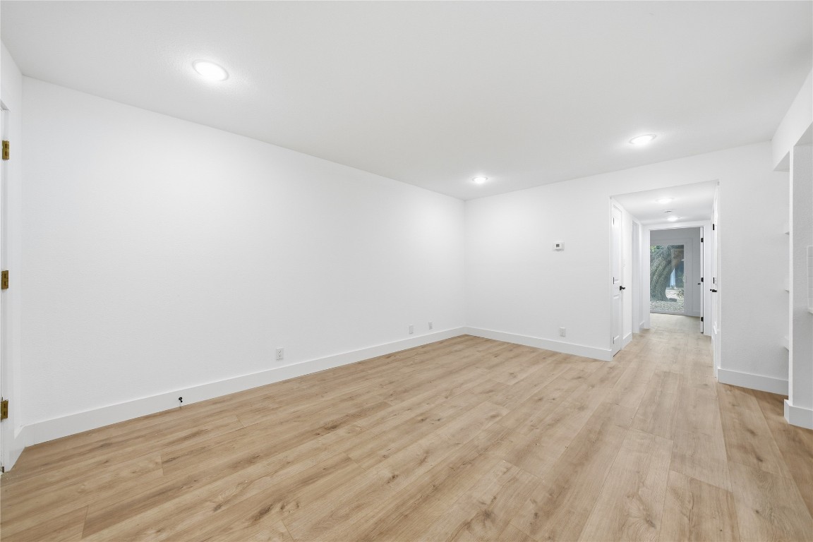 500 East Riverside Drive, Unit 133 Austin, TX 78704 - Photo 6 of 38 an empty room with wooden floor and windows