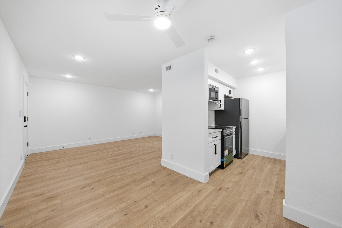 500 East Riverside Drive, Unit 133 Austin, TX 78704 - Photo 10 of 38 a view of a kitchen with a sink and a refrigerator