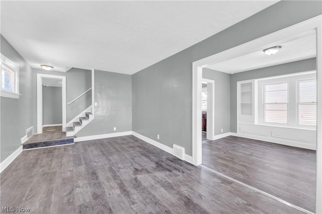 12808 Havana Road Cleveland, OH 44125 - Photo 4 of 19 Living area featuring wood-finish flooring, light gray wall tones, and white trim