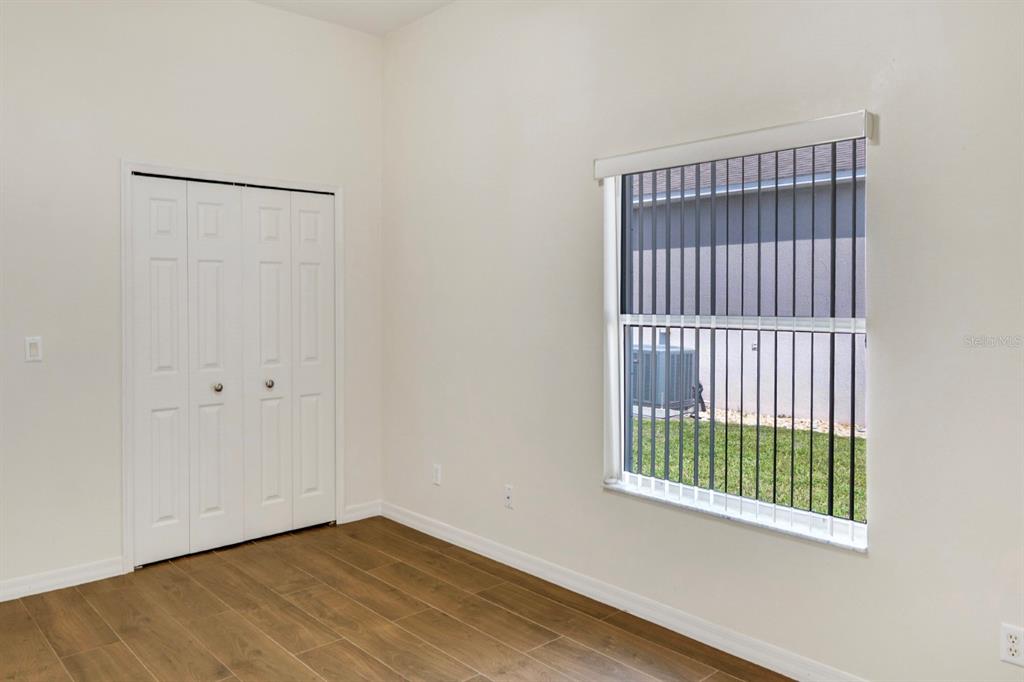 215 Strathmore Circle Kissimmee, FL 34744 - Photo 12 of 24 a view of an empty room with a window