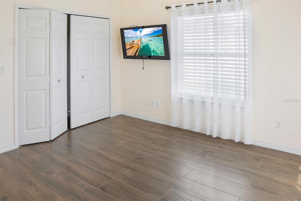 215 Strathmore Circle Kissimmee, FL 34744 - Photo 15 of 24 a view of a livingroom with wooden floor and window