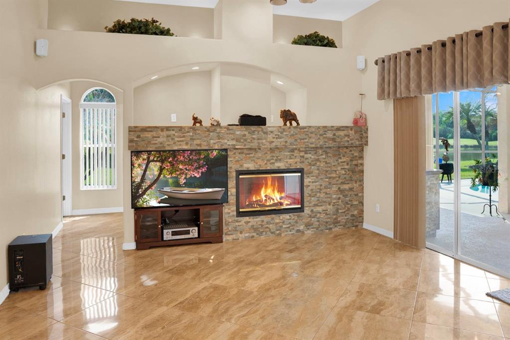 215 Strathmore Circle Kissimmee, FL 34744 - Photo 16 of 24 a living room with fireplace and a fireplace