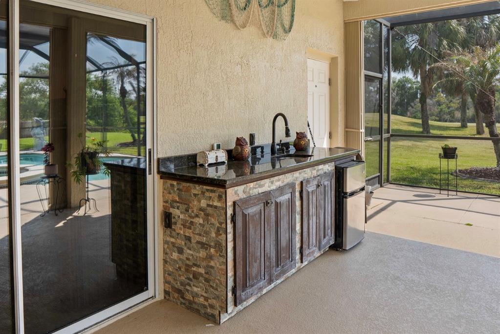 215 Strathmore Circle Kissimmee, FL 34744 - Photo 19 of 24 a kitchen with a sink and a refrigerator