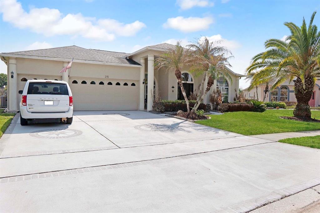 215 Strathmore Circle Kissimmee, FL 34744 - Photo 2 of 24 a car parked on the side of the road