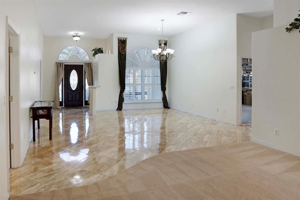 215 Strathmore Circle Kissimmee, FL 34744 - Photo 5 of 24 a view of a hallway with a chandelier