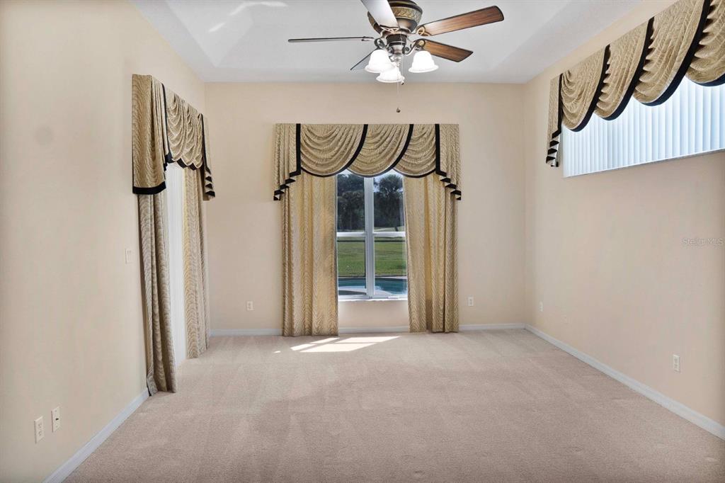 215 Strathmore Circle Kissimmee, FL 34744 - Photo 6 of 24 a view of a hallway with a white walls and wooden floor