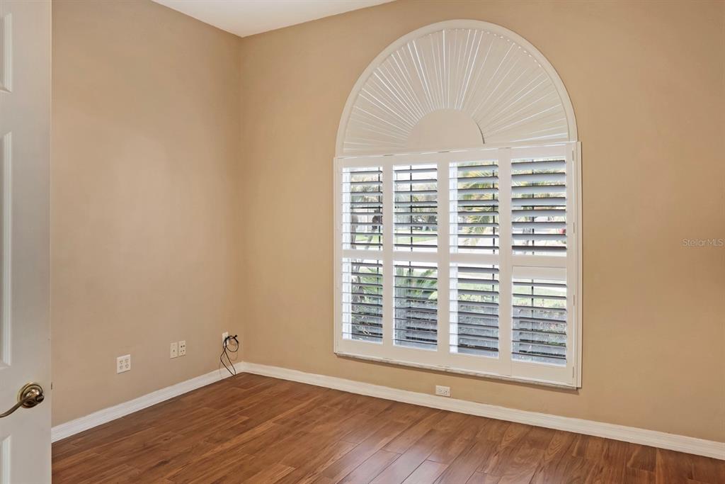 215 Strathmore Circle Kissimmee, FL 34744 - Photo 8 of 24 a view of an empty room with wooden floor and a window