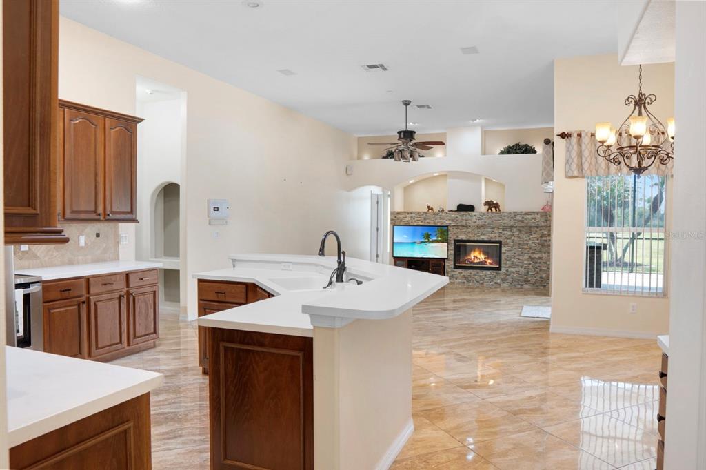 215 Strathmore Circle Kissimmee, FL 34744 - Photo 9 of 24 a kitchen with kitchen island granite countertop a sink cabinets and wooden floor