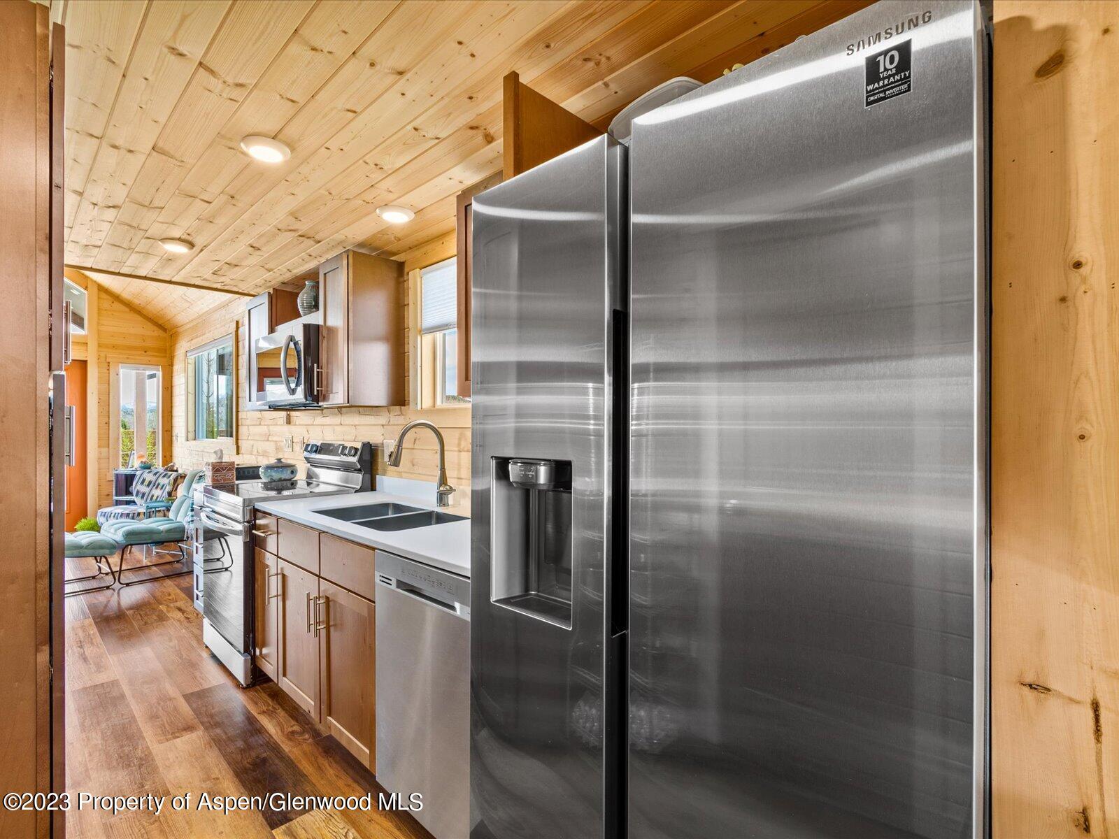329 River Frontage Road, Unit 8 Silt, CO 81652 - Photo 11 of 24 a kitchen with stainless steel appliances granite countertop a refrigerator a stove and a sink with dishwasher