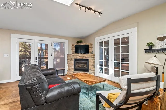 a living room with furniture a fireplace and a flat screen tv