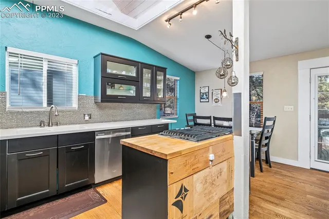 a kitchen that has a sink and a stove in it