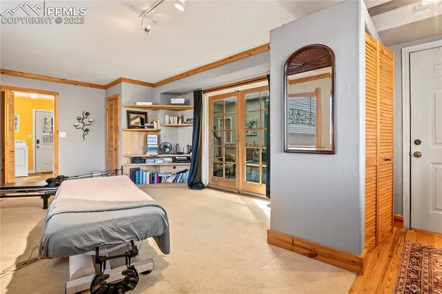 a bedroom with a bed and a large window with the outer view